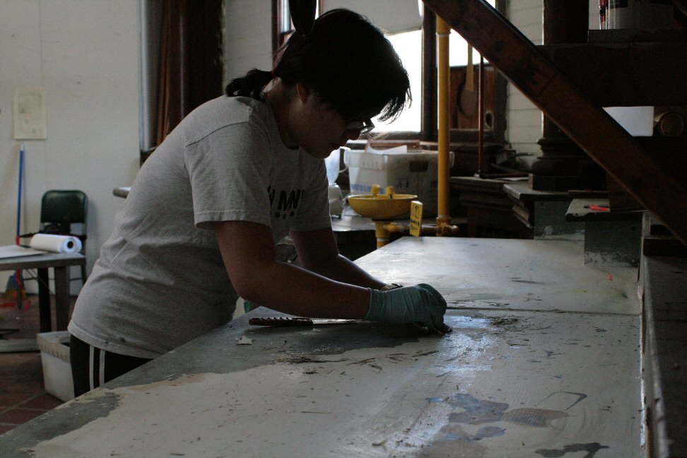 Angela stripping a table for repainting